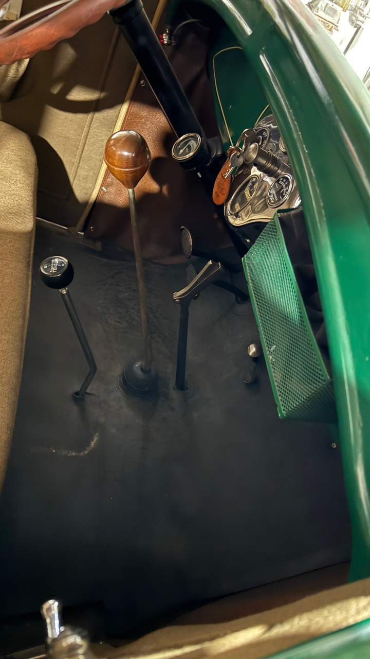 Front seat showing overdrive shifter. Dash basket is magnetic mounted